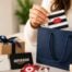 Gift cards from several popular brands displayed beside wrapped gifts and a gift bag, illustrating different gift card options for gifting.