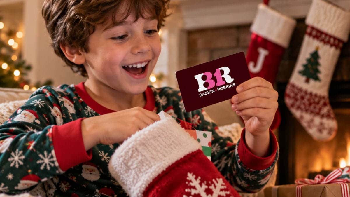 Boy pulling a Baskin-Robbins gift card from a Christmas stocking